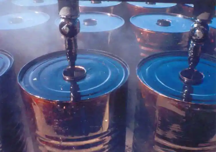 Hot Cutback Bitumen RC800 being filled into steel drums during ATDM production.