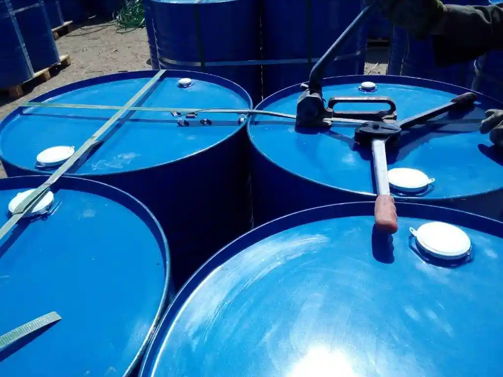 Bitumen SC800 blue steel drums being strapped and sealed for export shipment by ATDM.
