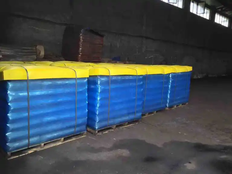 Palletized Gilsonite powder bags wrapped in blue and yellow packaging for export by ATDM.